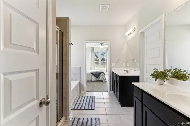 a en suite bathroom with a sink and a large mirror