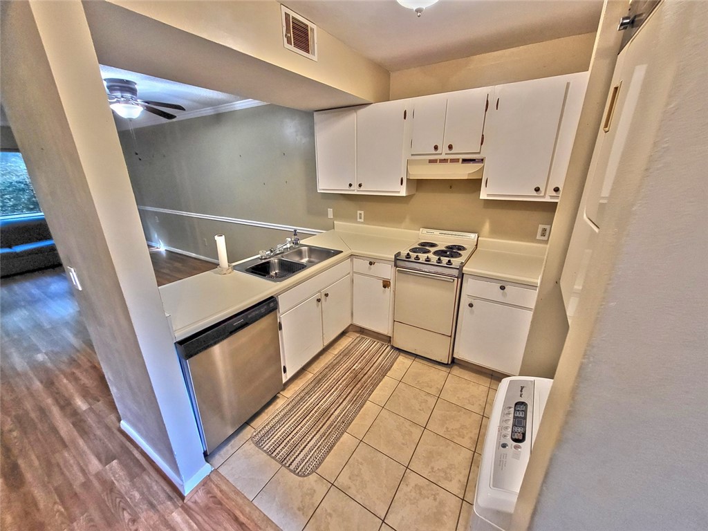 150 Ligon Street, Unit 1001 Clemson, SC 29631 - Photo 9 of 29 A compact kitchen with tile flooring and a pass-through window to the living area.