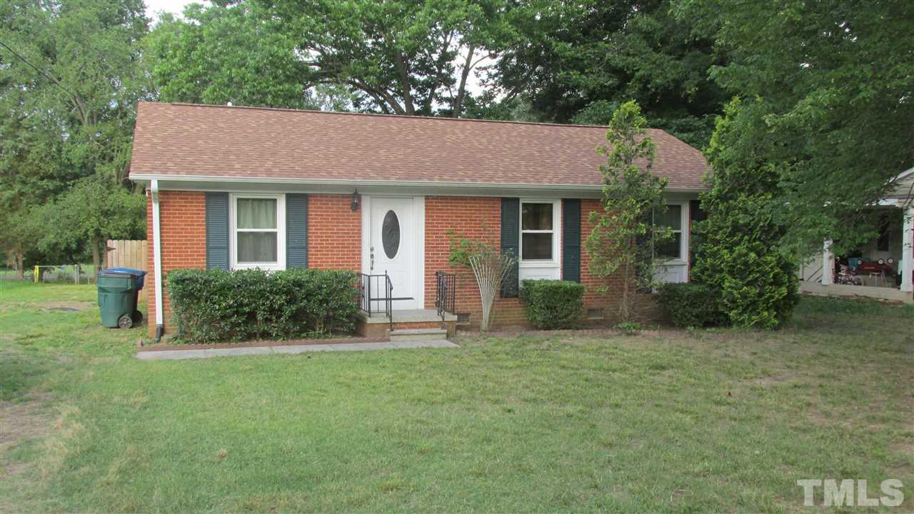 4823 Revere Road Durham, NC 27713 - Photo 1 of 15 a front view of a house with a yard