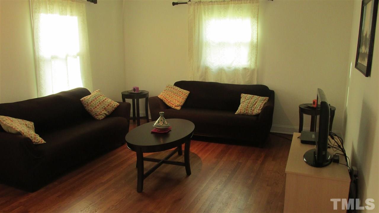 4823 Revere Road Durham, NC 27713 - Photo 2 of 15 a living room with furniture and a window