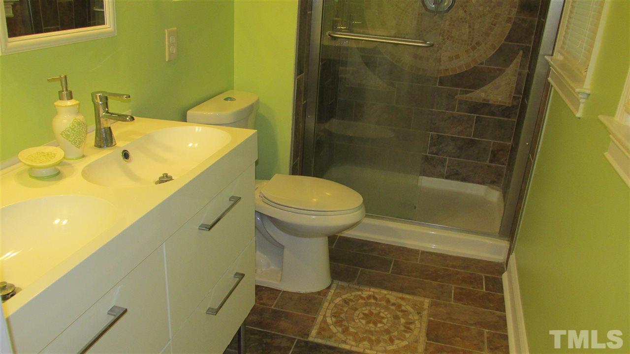 4823 Revere Road Durham, NC 27713 - Photo 9 of 15 a bathroom with a sink and a toilet