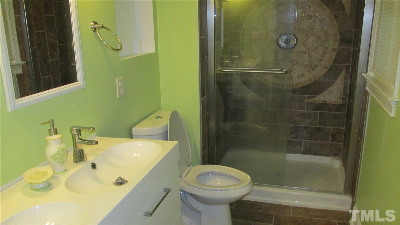 4823 Revere Road Durham, NC 27713 - Photo 10 of 15 a bathroom with a sink toilet and shower