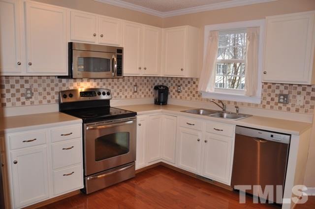 8512 Powis Circle Raleigh, NC 27615 - Photo 8 of 25 a kitchen with granite countertop white cabinets stainless steel appliances and a sink