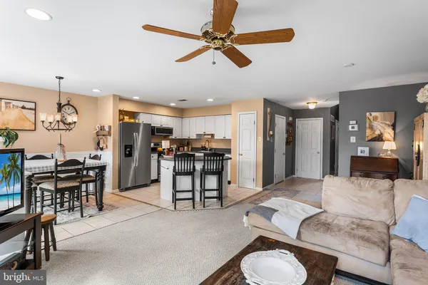 a kitchen with stainless steel appliances white cabinets white stove a refrigerator and a sink