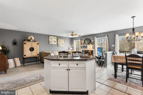 a kitchen with stainless steel appliances kitchen island granite countertop a sink and cabinets