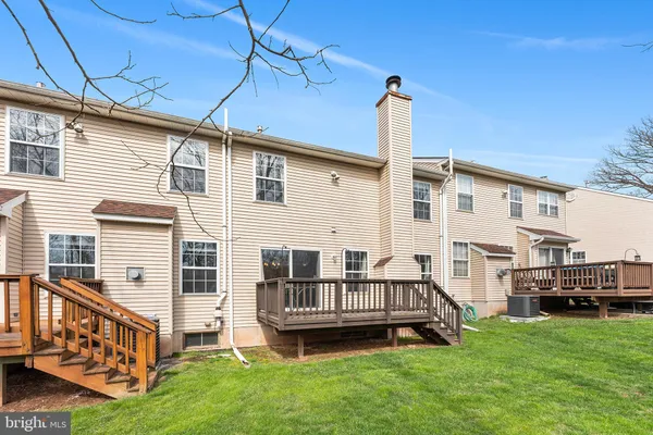 a view of a house with backyard and deck