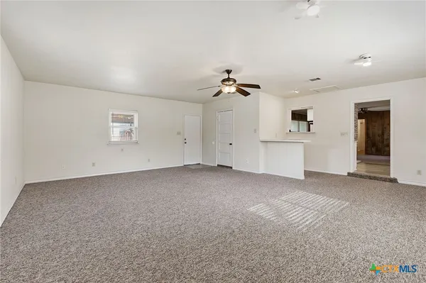 an empty room with a empty space and windows