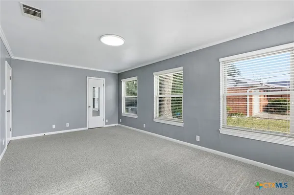 a view of an empty room with a window