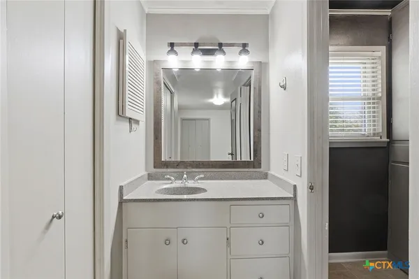 a bathroom with a sink and a mirror