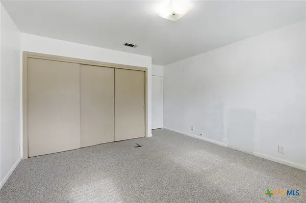 an empty room with cabinet door