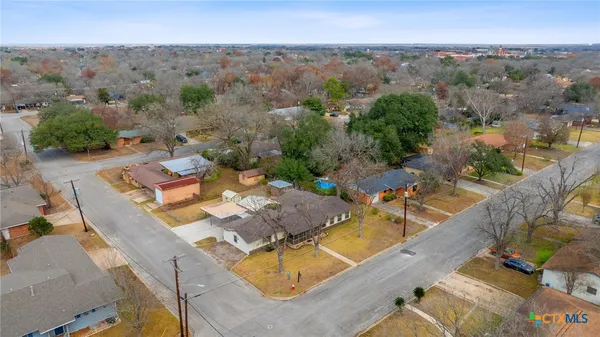 an aerial view of a house with a swimming pool