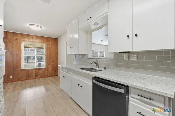 a kitchen with a sink stove and cabinets