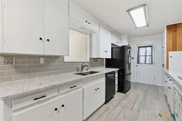 a kitchen with a sink stove and refrigerator