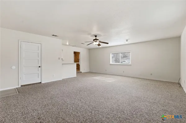 an empty room with a empty space and windows