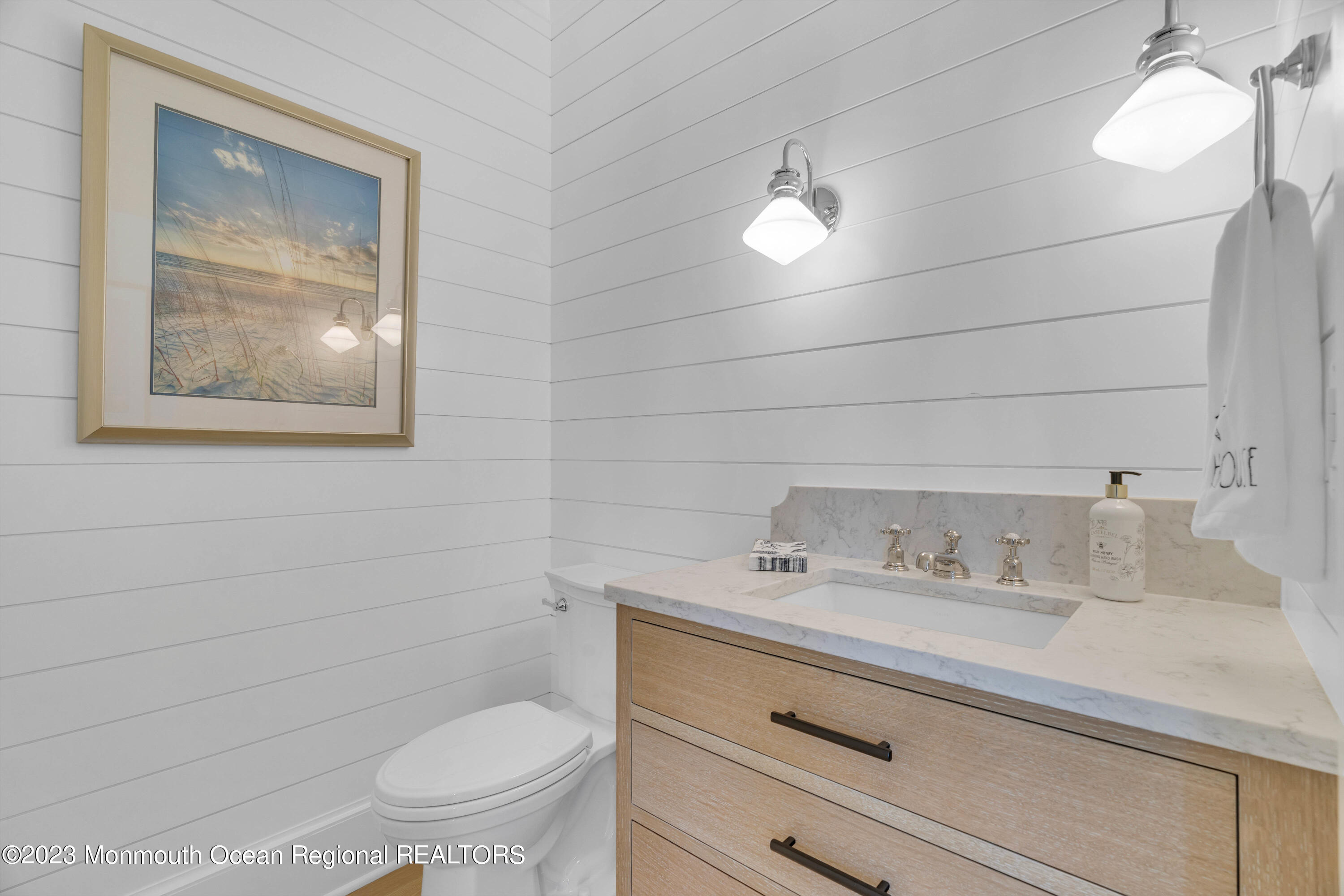 1407 Ocean Avenue Mantoloking, NJ 08738 - Photo 17 of 41 a bathroom with a toilet sink vanity and mirror