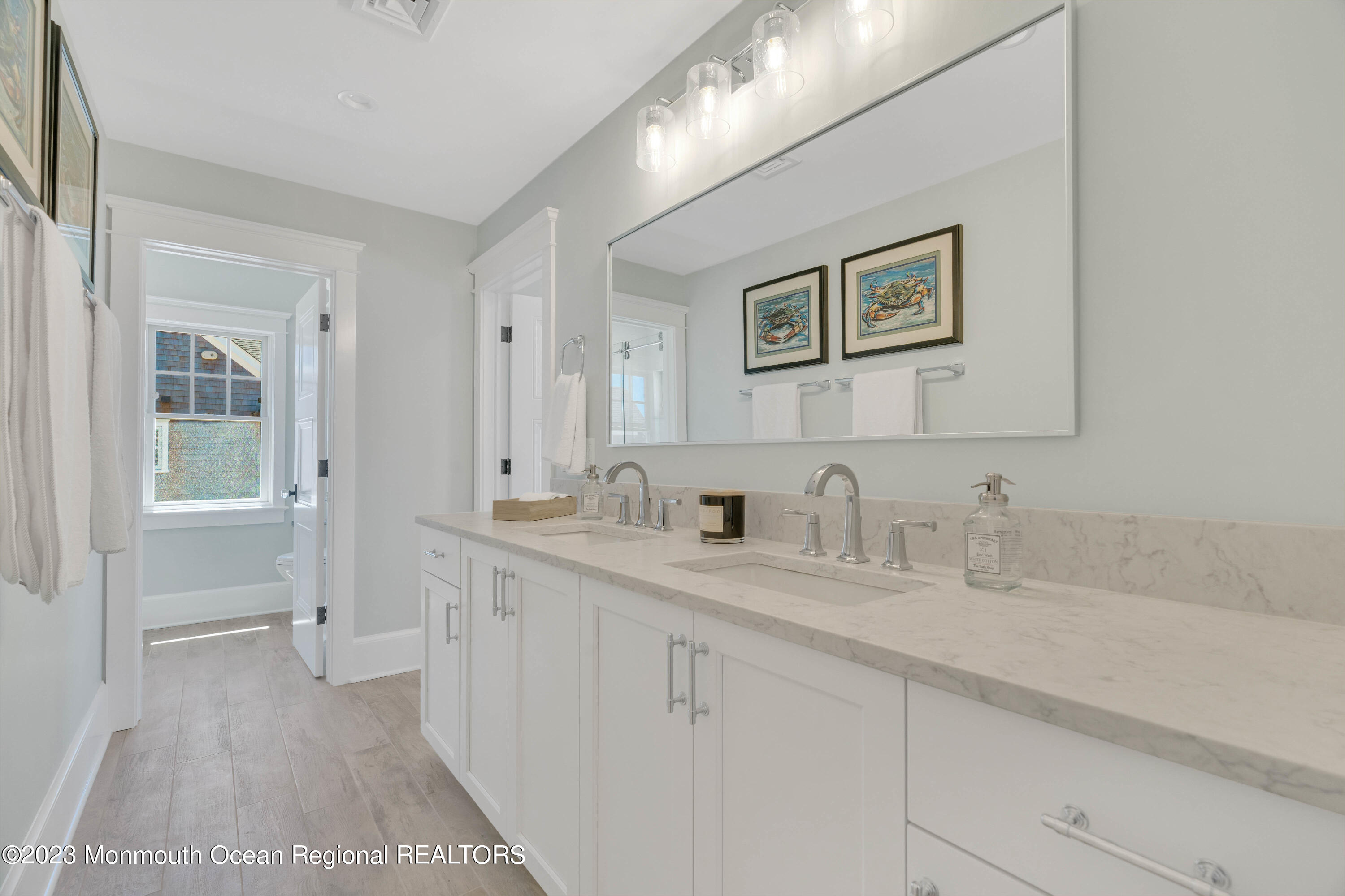 1407 Ocean Avenue Mantoloking, NJ 08738 - Photo 20 of 41 a bathroom with a double vanity sink and a mirror