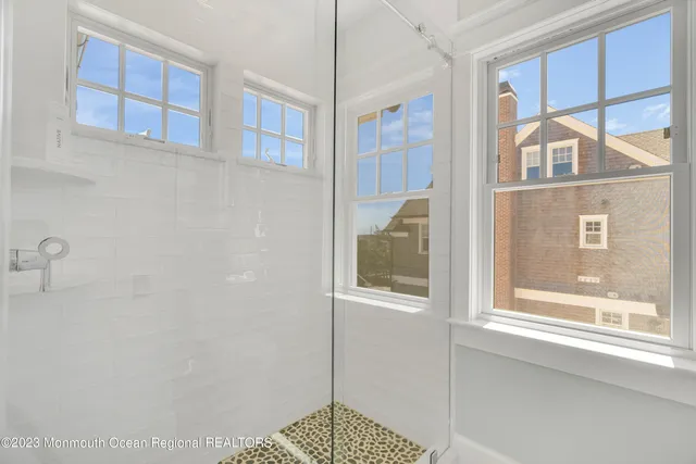 a bathroom with a granite countertop sink a toilet and shower
