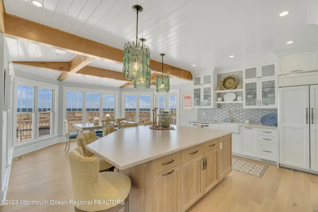 a dining room with furniture and floor to ceiling window