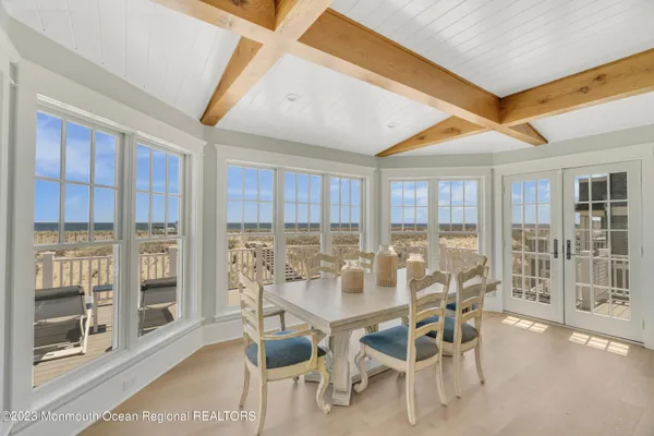 a living room with a table chairs and a table