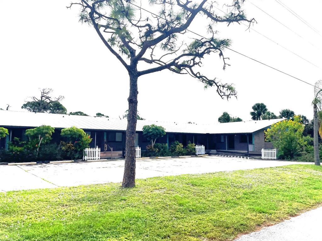 9000 Griggs Road, Unit C Englewood, FL 34224 - Photo 2 of 14 a swimming pool with outdoor seating and yard