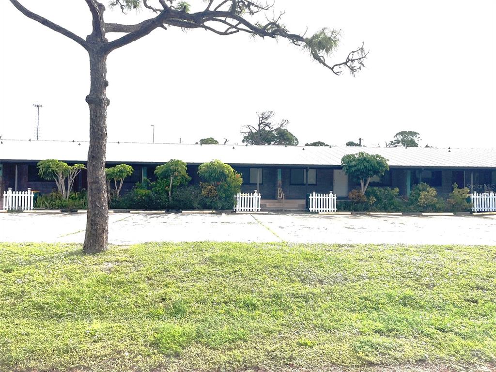 9000 Griggs Road, Unit C Englewood, FL 34224 - Photo 3 of 14 a view of swimming pool with a patio and a yard