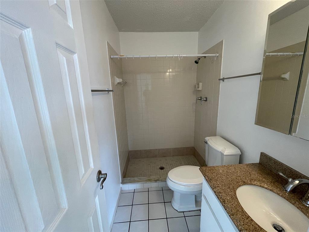 9000 Griggs Road, Unit C Englewood, FL 34224 - Photo 9 of 14 a white toilet sitting next to a bathroom sink