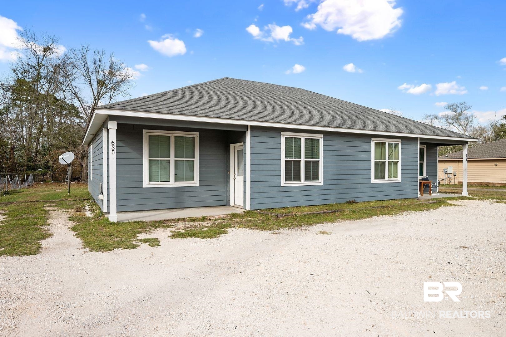 635 East Azalea Avenue Foley, AL 36535 - Photo 1 of 18 Single-story residence featuring blue horizontal siding and a dark gray shingle roof