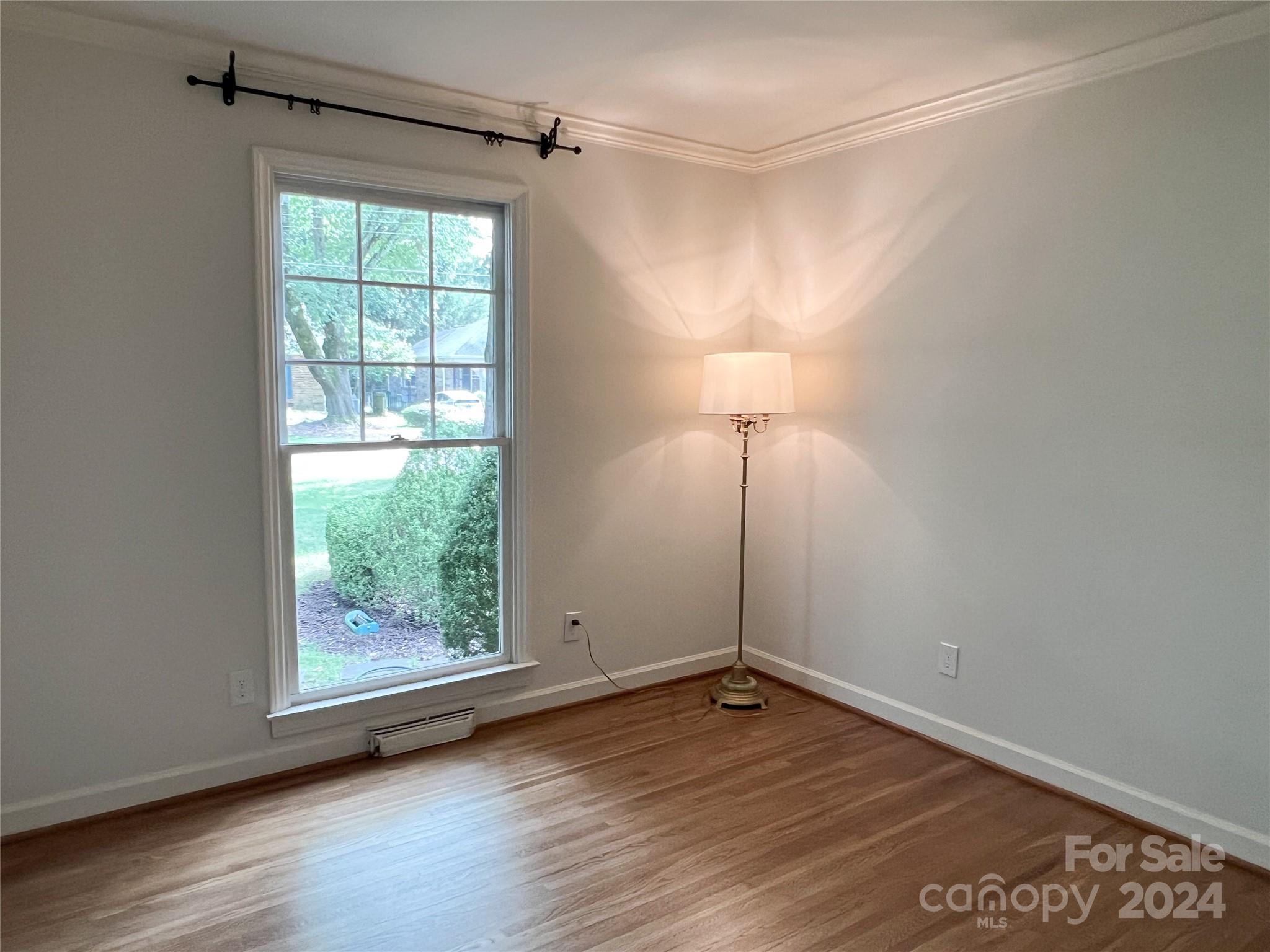 4115 Rutherford Drive Charlotte, NC 28210 - Photo 15 of 26 an empty room with wooden floor and windows