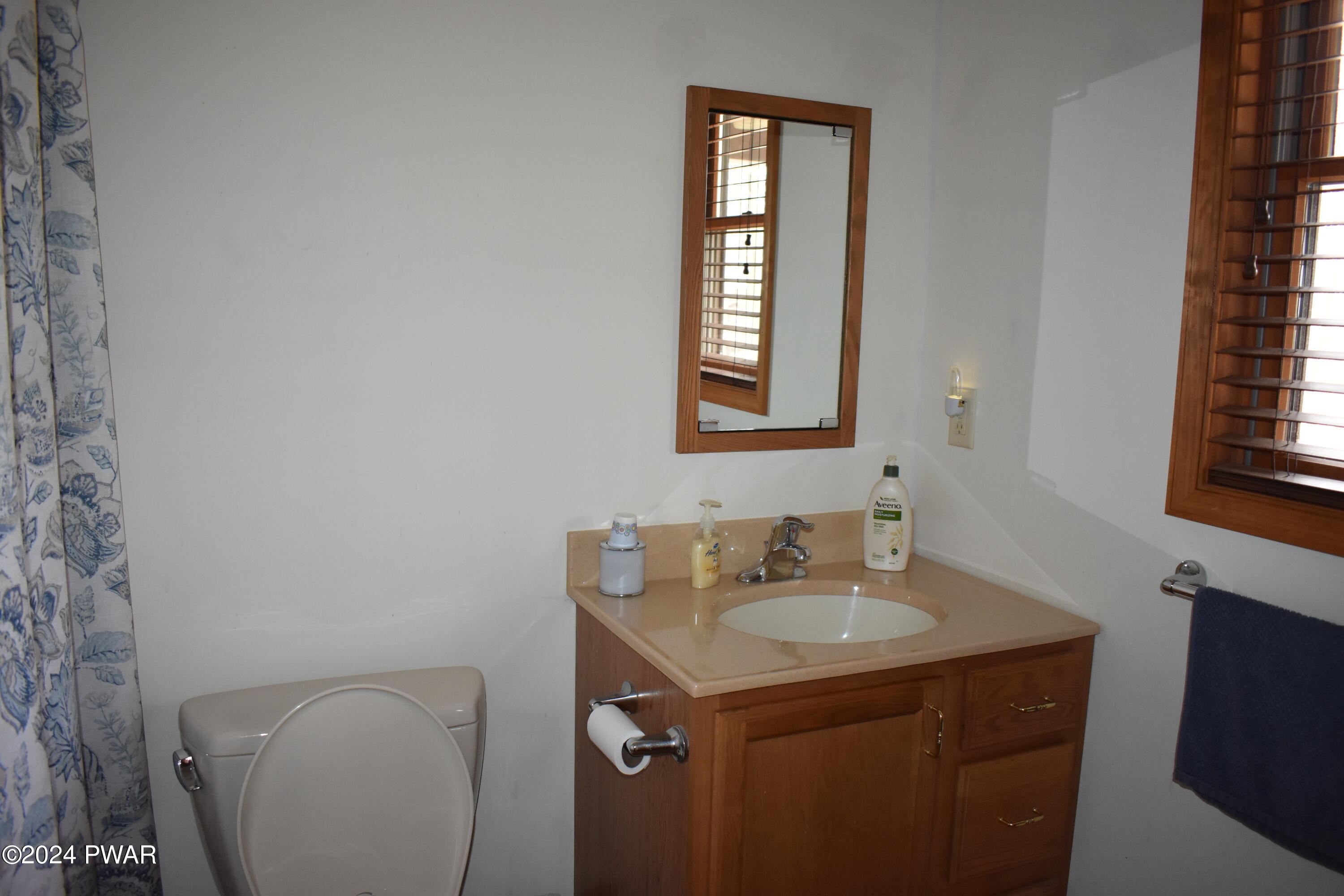 800 Rimrock Court Hawley, PA 18428 - Photo 15 of 30 a bathroom with a sink a toilet and a window