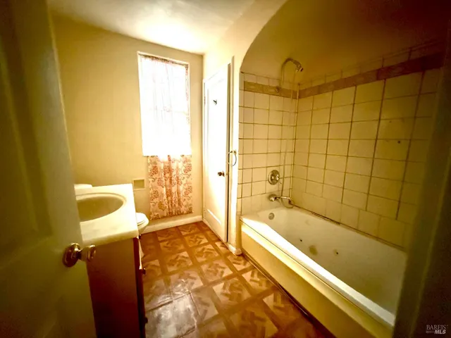 a bathroom with a bathtub and shower