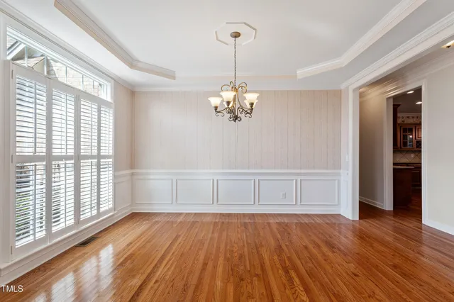 a view of a livingroom with wooden floor and a fireplace