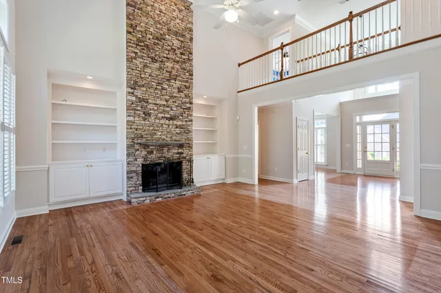a view of an entryway with wooden floor door and a window