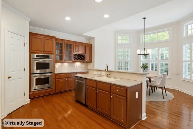 a kitchen with stainless steel appliances granite countertop a stove a refrigerator and a sink