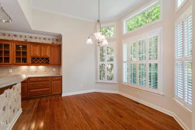 a view of a hallway with wooden floor and closet area