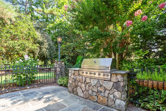 a living room with furniture a fireplace and large windows