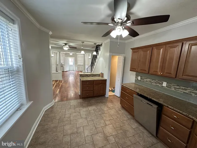 a kitchen with stainless steel appliances granite countertop a sink and a stove
