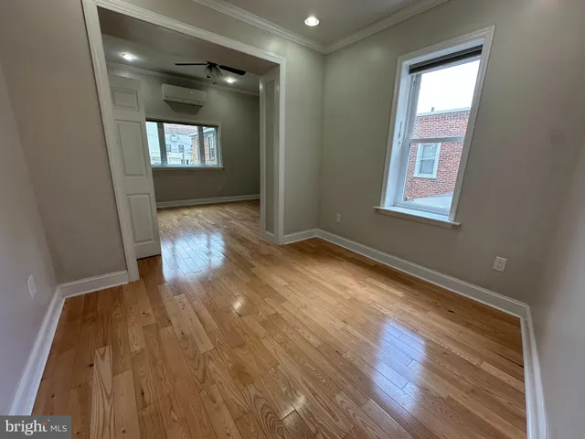 wooden floor in an empty room with a window