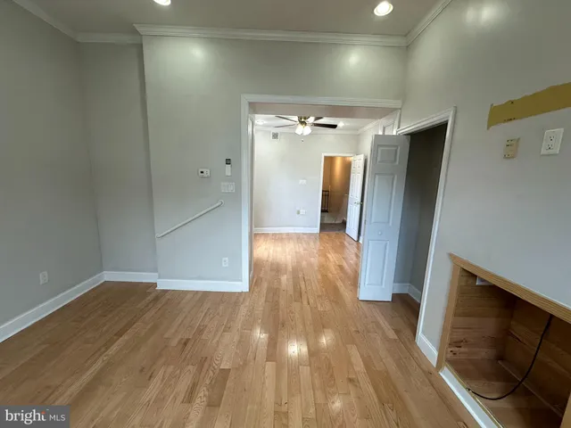 a view of hallway with wooden floor