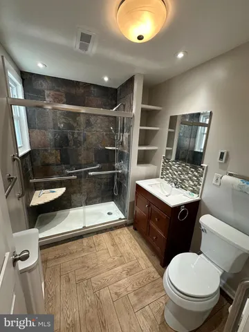 a bathroom with a sink toilet and shower
