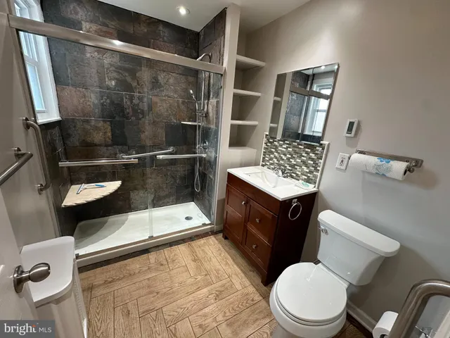 a bathroom with a toilet a sink and shower