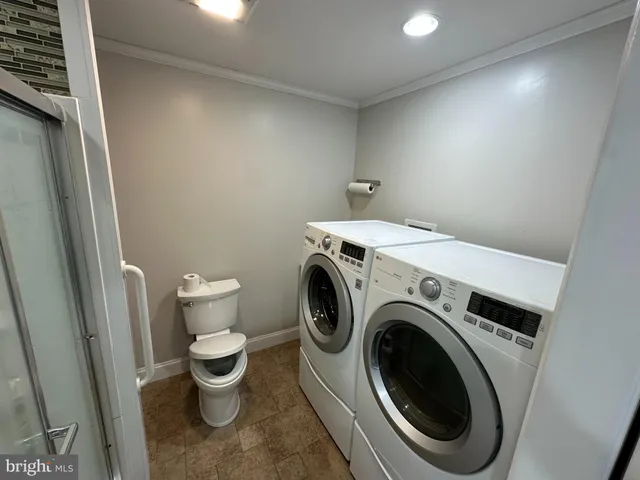 a view of a storage & utility room with a washer dryer