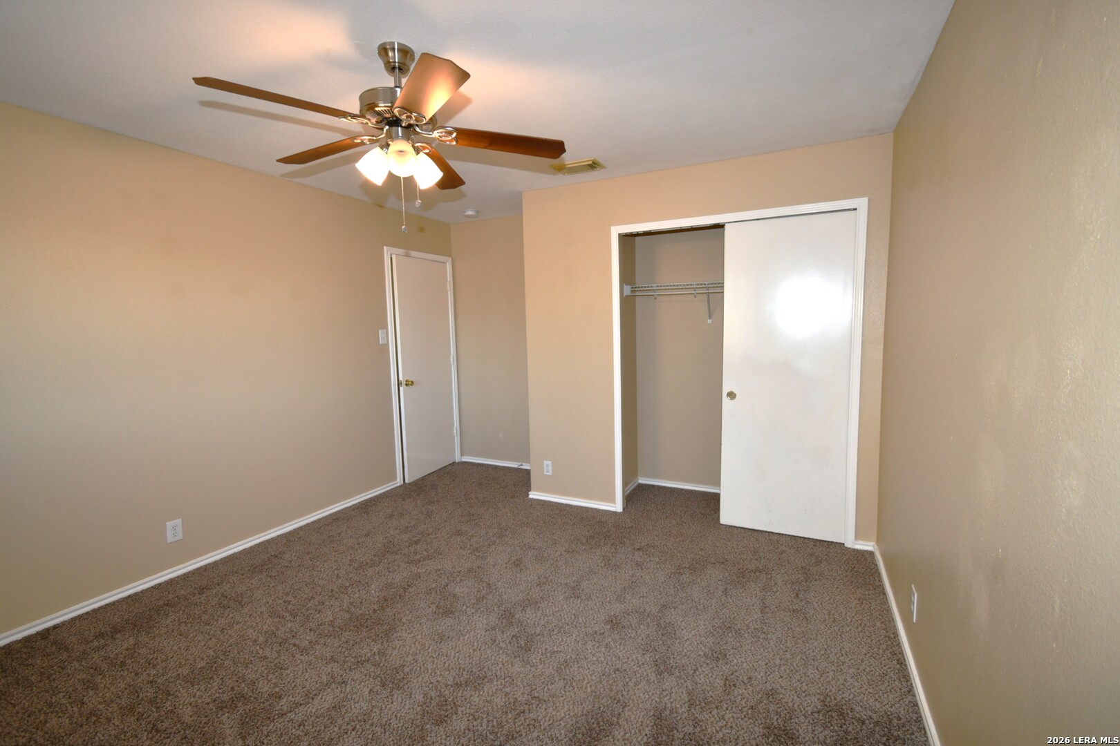 8834 Ridgefront San Antonio, TX 78250 - Photo 18 of 20 a view of an empty room with a chandelier fan