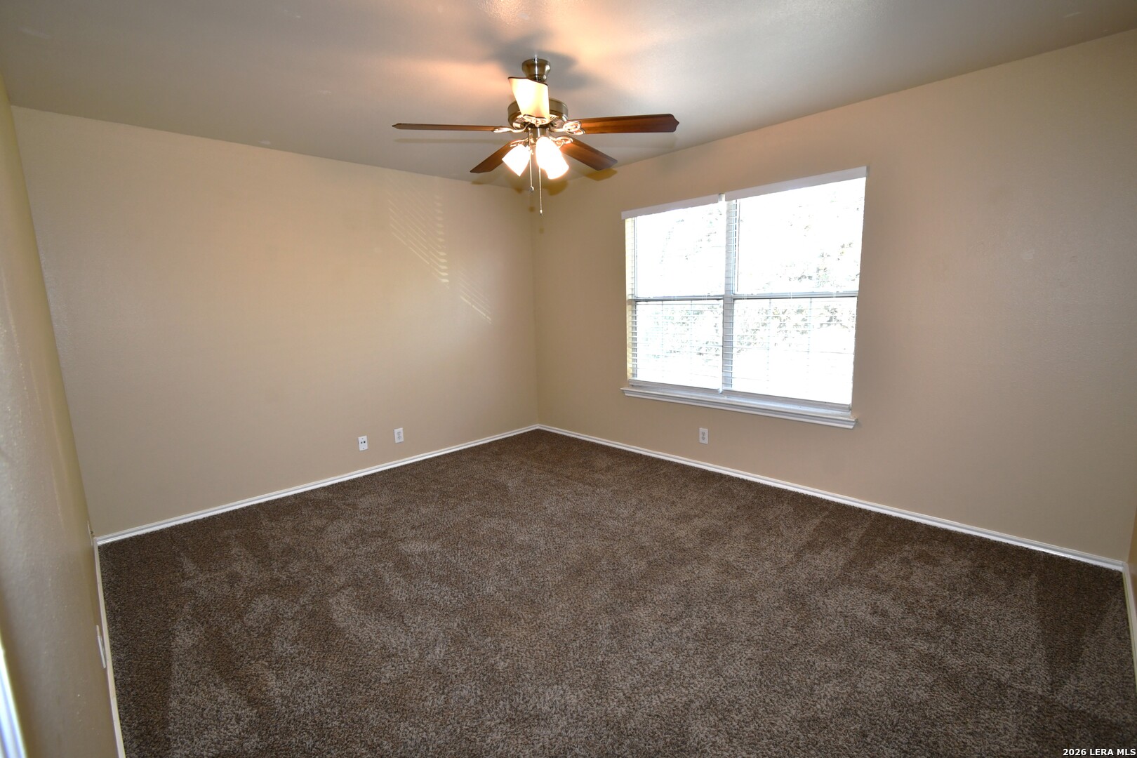 8834 Ridgefront San Antonio, TX 78250 - Photo 19 of 20 an empty room with a window