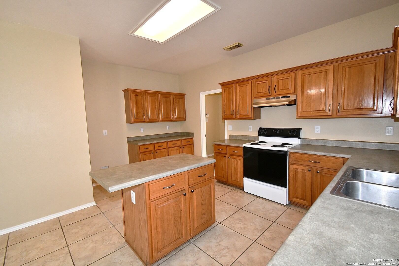 8834 Ridgefront San Antonio, TX 78250 - Photo 6 of 20 a kitchen with stainless steel appliances granite countertop a stove a sink and a refrigerator