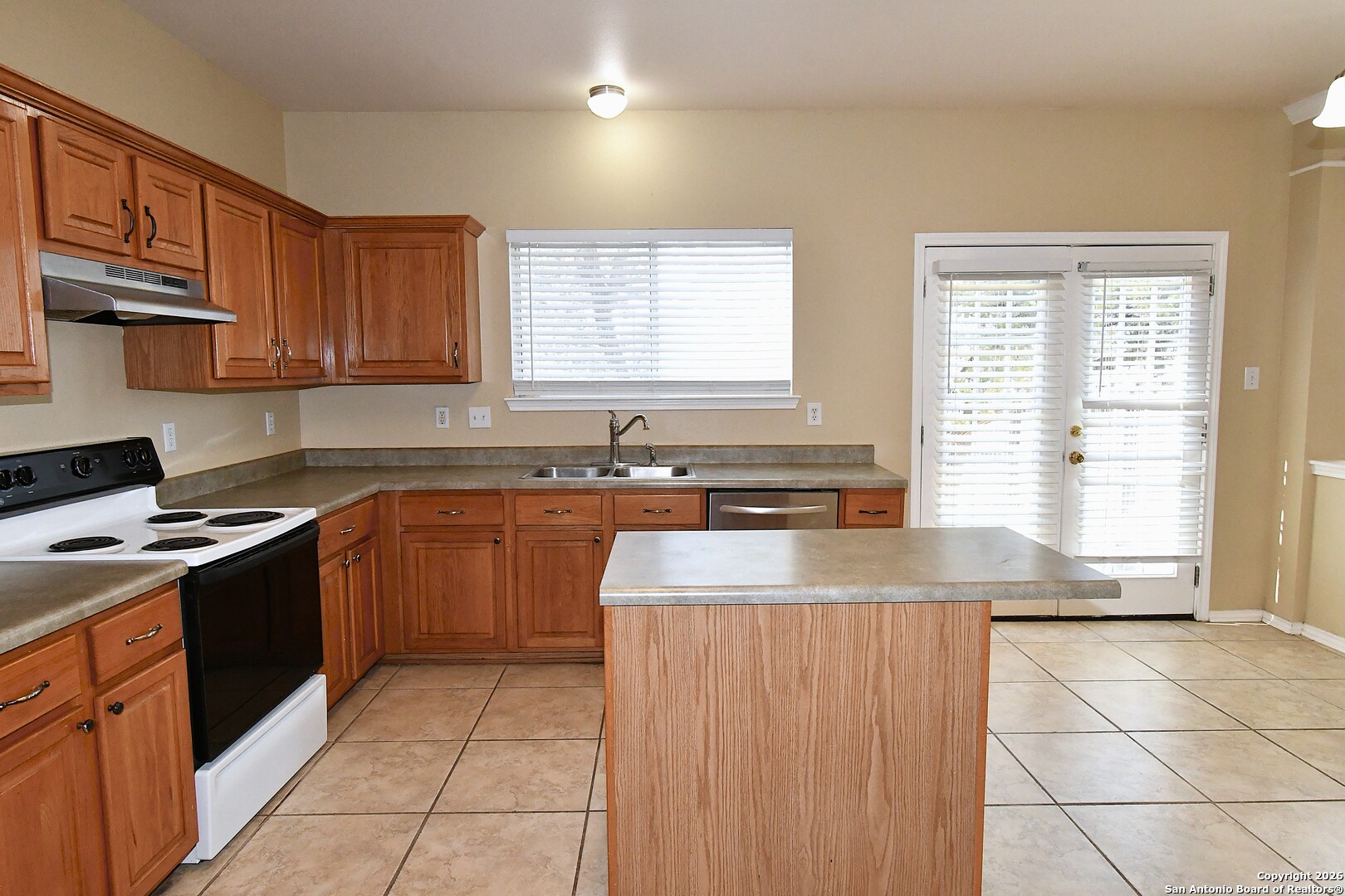 8834 Ridgefront San Antonio, TX 78250 - Photo 7 of 20 a kitchen with stainless steel appliances granite countertop a sink stove and refrigerator