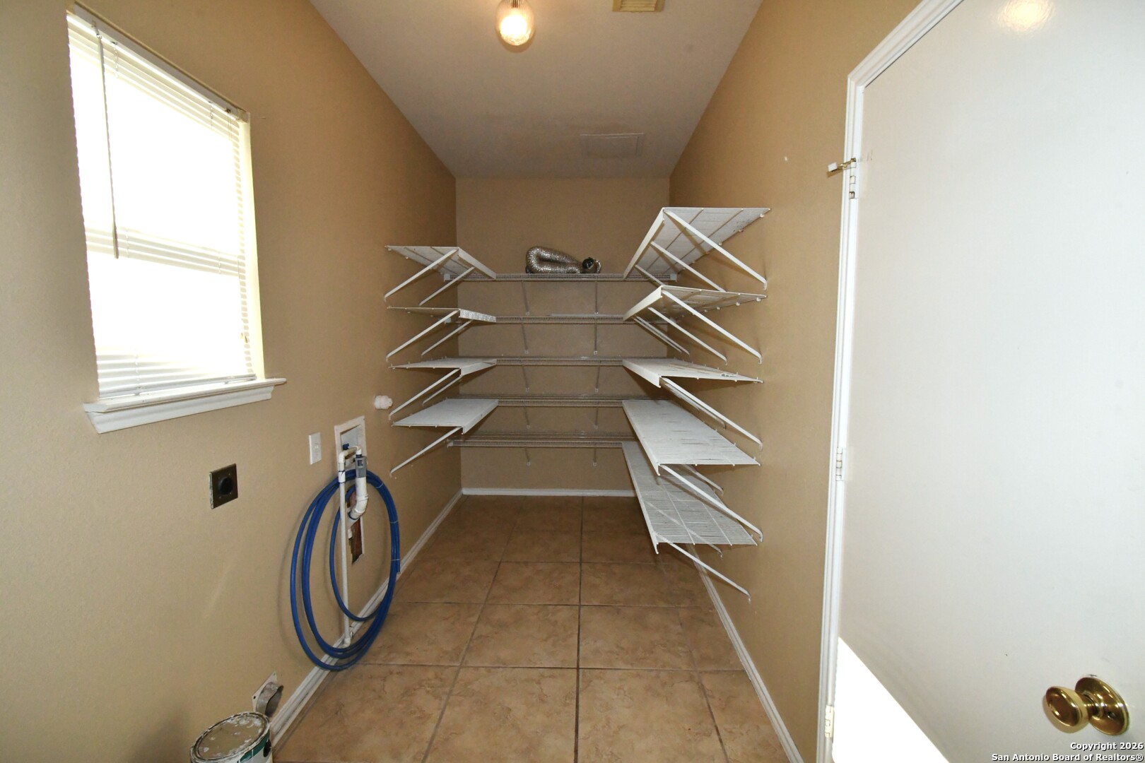 8834 Ridgefront San Antonio, TX 78250 - Photo 8 of 20 a view of a room with rack on the wall