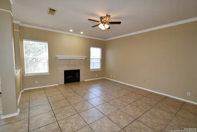 a view of an empty room with a fireplace and a window