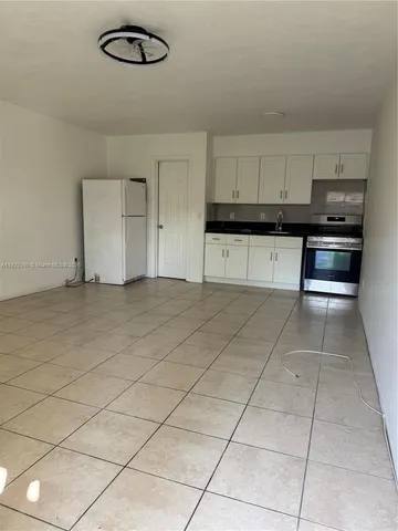 a kitchen with kitchen island cabinets and window