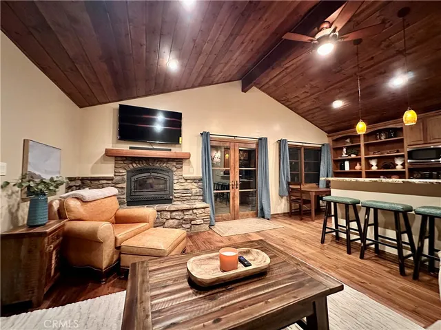 a living room with furniture a flat screen tv and kitchen view
