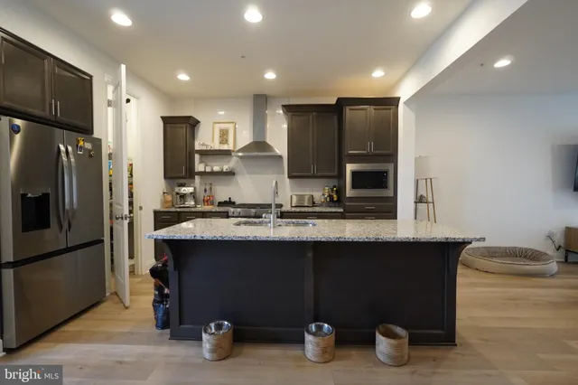 a kitchen with sink and refrigerator